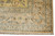 Corner detail showing beige main border, light blue guard stripes and hand-knotted wool fringe