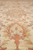 Macro shot of soft wool pile with coral medallion motif and brown vine outlines