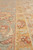 Close up of light blue main border and gold floral guard stripe, hand-knotted wool