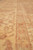 Macro view of guard border stripes in apricot and terracotta across the natural wool pile