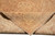 Folded back corner revealing the tight hand-knotted weave, cotton foundation and short wool pile