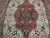 Close-up of teal center medallion with pink rosettes and blue blossoms on ivory Tabriz field
