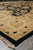 Low angle along the 9 x 12 rug corner, black outer band and fringe