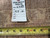Back of the rug with hand-woven tag number 6328 and tape measure showing knot density