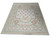 Full length floor display of French Aubusson style flat weave area rug in light green and ivory