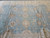 Close view of the light blue field with ivory rosettes, brown octagons and storage fold lines