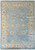 Light blue Oushak rug with ivory border and camel palmettes, full overhead view of wool pile
