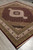 Formal 8 by 10 area rug seen from the corner showing multi band ivory border
