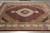 8' x 10' wool and silk rug on grey tile floor showing full medallion layout