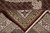 Folded corner revealing the even hand-knotted back, cotton foundation weave and ivory fringe end