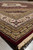 Low angle across the rug showing the border stack, ivory fringe and soft silk sheen