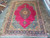 9'4 x 13'1 Persian Tabriz rug laid flat on stone floor showing navy border
