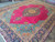 9x13 Persian Tabriz rug at an angle, showing turquoise corner florals and dense wool pile