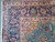 Close-up of navy main border and ivory guard stripes with pink and brown palmettes