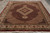 8x10 Mahi Tabriz design rug angled in showroom with ivory border and burgundy Herati field