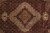 Detail of ivory subfield, black medallion outline and olive palmette tips at rug center