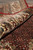 8'3" x 9'9" rug rolled back to reveal pile depth and ivory border