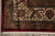 Border corner detail with ivory ground, curled leaves, red palmettes and clean cotton fringe