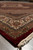 8x10 wool and silk rug seen low along the edge, lustrous pile and ruby band