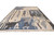 Angled view of the 11'10" x 18'10" oversize contemporary wool rug showing charcoal, blue and ivory panels