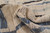 Close-up of thick half-inch wool pile rolled back, showing soft ivory and slate blue hand-knotted texture