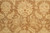 Field detail showing large ivory palmettes, rosettes and scrolling vines across neutral brown ground