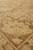 Angled close view where the ivory border meets the camel field, showing clear knot definition
