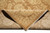 Folded corner reveals the tight hand-knotted back and dense natural wool pile of this rug