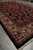 Side angle of the 6'9" x 10'8" Sarouk showing border scrolls and black outer edge