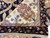 8x10 Indian Agra rug corner folded back to show rust poppy sprays on ivory