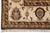 Corner detail with ivory border, brown outer band, cotton fringe and dense hand-knotted wool pile