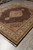 Wool and silk 8x10 rug seen from one corner showing border, medallion and pile sheen