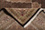 Folded corner revealing the tight weave and black selvedge beside the ivory border and fringe