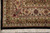 Corner detail of ivory border, rust palmettes, black outer band and hand-tied cotton fringe
