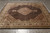 8'2" x 10'2" Indo-Tabriz Mahi rug lying flat on grey tile showroom floor