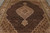 Close angled view of the ivory lobed medallion floating on the dense black Herati field