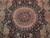 Close-up of the beige sunburst medallion with radiating rays and scalloped floral ring on black