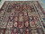 Khesti panel design close up featuring cypress trees, stepped medallions and floral sprays in rich wool