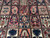 Detail of salmon, navy and burgundy garden squares with stylized tulips, palmettes and leaf motifs