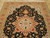 5' x 6'9" Tabriz rug detail showing the 8 point medallion in rust against black field