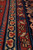 Macro shot of navy guard borders with ivory and red trefoil motifs on dense pile