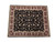 Black wool and silk area rug photographed flat, showing ivory fringe and layered burgundy floral borders
