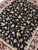 Overhead 8 by 10 rug detail showing symmetrical floral repeat in ivory, rose and green