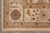 Corner detail with mauve rosette, cypress motif and hand-tied cotton fringe on ivory ground
