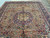 Half view of the 10x13 Tabriz rug on tile floor, brown field with all over floral design