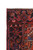 Corner detail of the black border with rosettes, ivory fringe and thick hand-knotted wool pile