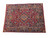 Angled studio view of a large burgundy and navy hand-knotted wool rug from Khorasan
