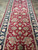 Overhead pattern detail with ivory rosette, lotus blossoms and curling vines on crimson ground