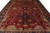 Close overhead detail of red ground, navy palmettes, olive leaves and gold flowering vinework