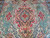 Close view of the red and salmon medallion with green palmettes on this 10x14 Tabriz
